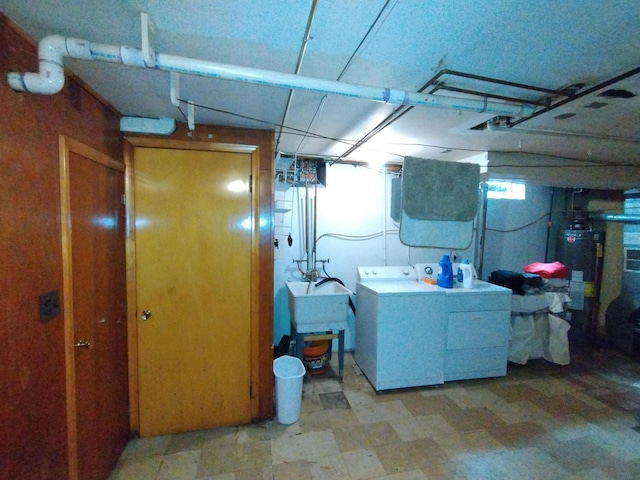 8383 Dixie Ln, Dearborn Heights, MI 48127 - basement featuring washing machine and clothes dryer, light floors, and gas water heater