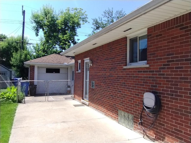 8383 Dixie Ln, Dearborn Heights, MI 48127 - view of side of home with concrete driveway, brick siding, a gate, and a garage