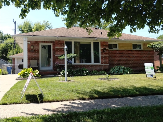 8383 Dixie Ln, Dearborn Heights, MI 48127 - view of front of home with brick siding, a front yard, and driveway