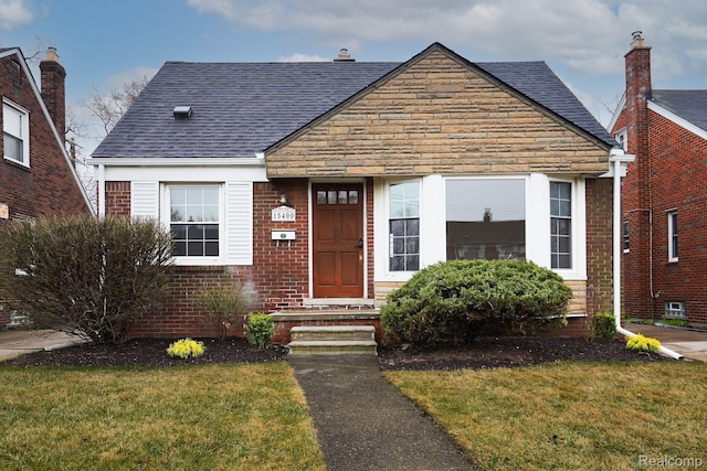 15400 Sprenger Ave, Eastpointe, MI 48021 - view of front facade featuring a front lawn, roof with shingles, and brick siding