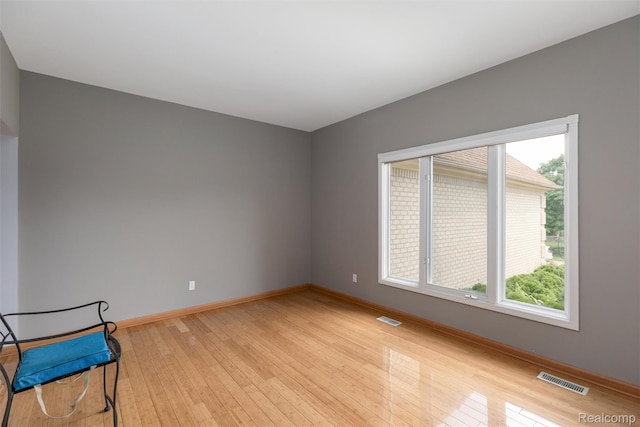 2479 Waterfront Dr, Brighton, MI 48114 - unfurnished room featuring light wood-style floors, plenty of natural light, and baseboards