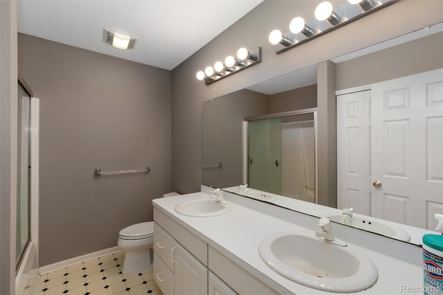 2479 Waterfront Dr, Brighton, MI 48114 - bathroom with double vanity, toilet, tile patterned floors, and baseboards