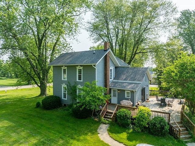 888 E Saint Joe Hwy, Grand Ledge, MI 48837 - back of property with a yard, a chimney, a deck, and roof with shingles