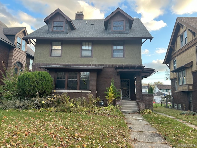 70 Colorado St, Highland Park, MI 48203 - american foursquare style home with a chimney, roof with shingles, brick siding, and a front yard