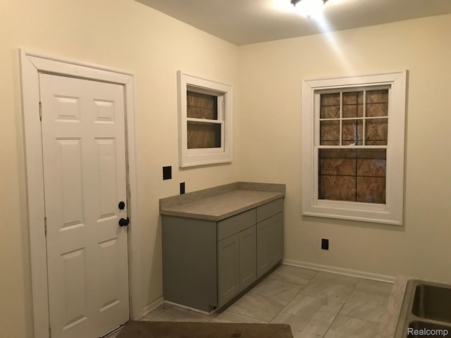 70 Colorado St, Highland Park, MI 48203 - laundry area with baseboards and light marble finish floors