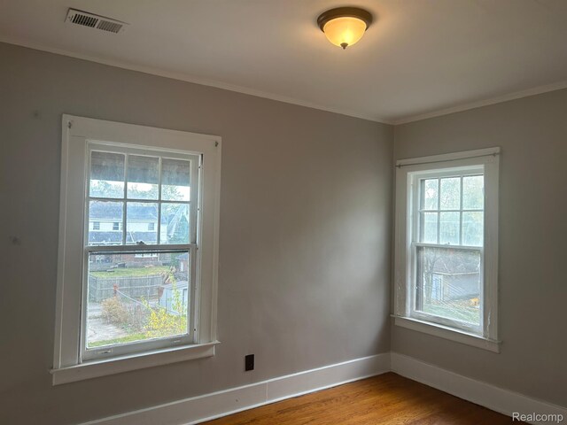 70 Colorado St, Highland Park, MI 48203 - spare room featuring baseboards, wood finished floors, and crown molding