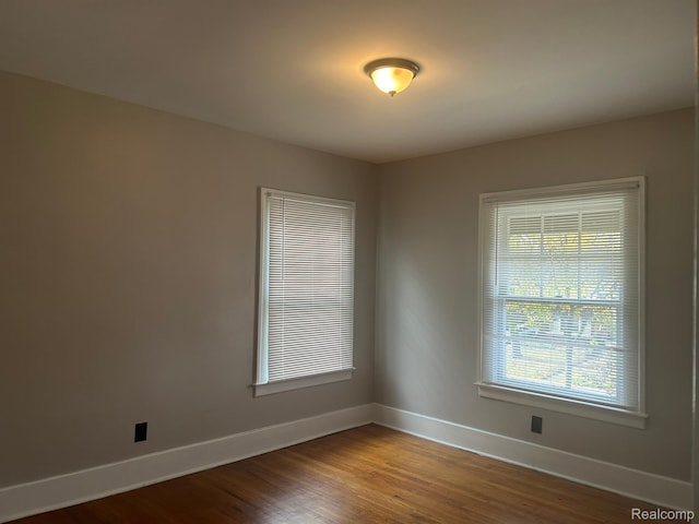 70 Colorado St, Highland Park, MI 48203 - empty room with baseboards, healthy amount of natural light, and wood finished floors