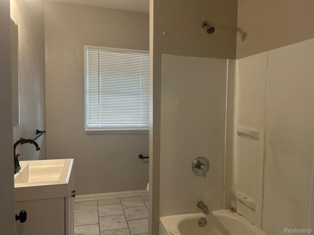 70 Colorado St, Highland Park, MI 48203 - bathroom with marble look tiles, vanity, shower / tub combination, baseboards, and toilet