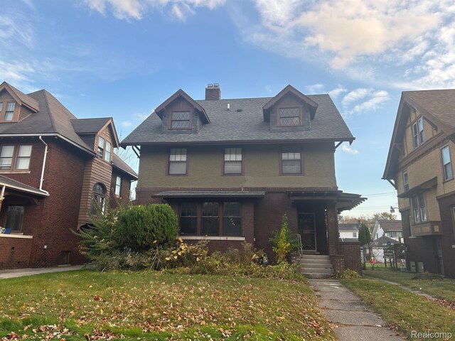 70 Colorado St, Highland Park, MI 48203 - american foursquare style home with a chimney, brick siding, and a front yard
