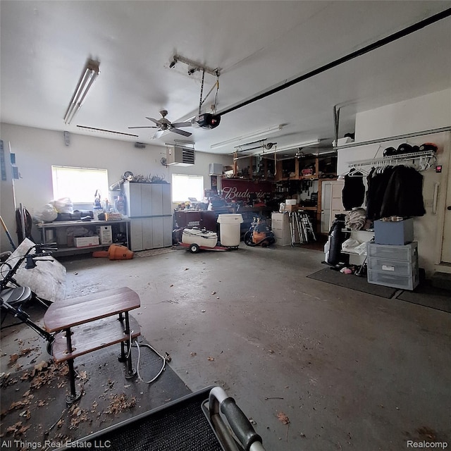 3827 Woodland Dr, Metamora, MI 48455 - garage with ceiling fan, a workshop area, and a garage door opener