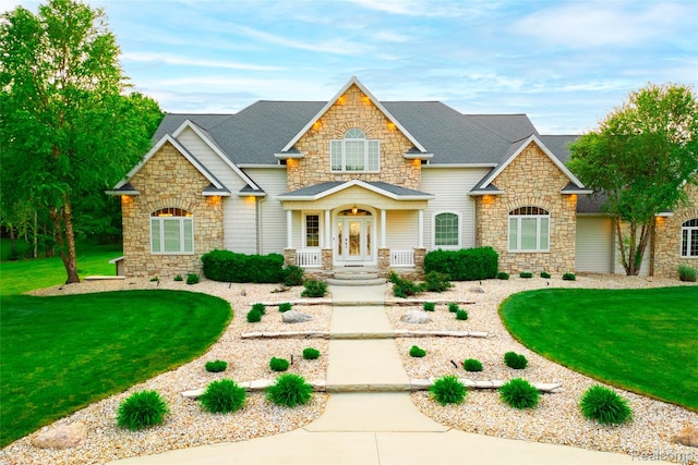 6312 S Graham Rd, Saint Charles, MI 48655 - craftsman house featuring stone siding, a front yard, and roof with shingles