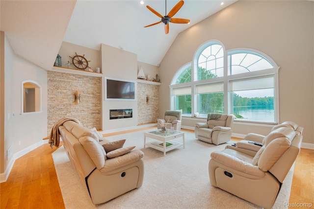 6312 S Graham Rd, Saint Charles, MI 48655 - living area featuring high vaulted ceiling, wood finished floors, ceiling fan, baseboards, and a glass covered fireplace