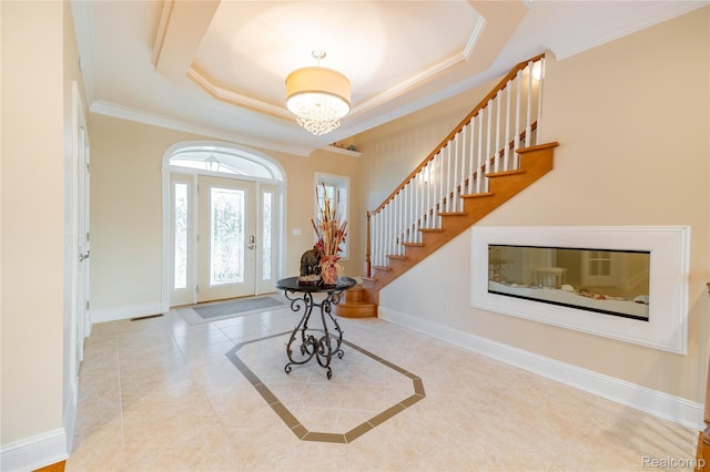 6312 S Graham Rd, Saint Charles, MI 48655 - tiled foyer with crown molding, stairs, a raised ceiling, baseboards, and a chandelier