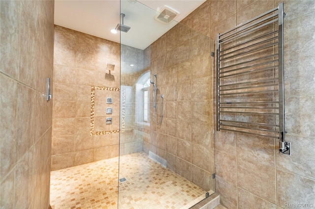 6312 S Graham Rd, Saint Charles, MI 48655 - bathroom featuring radiator heating unit and tiled shower