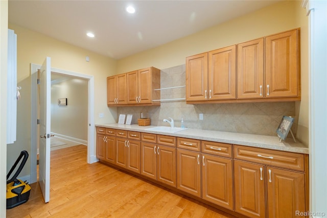 6312 S Graham Rd, Saint Charles, MI 48655 - kitchen featuring a sink, light countertops, backsplash, light wood-style floors, and open shelves