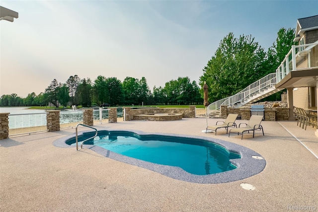 6312 S Graham Rd, Saint Charles, MI 48655 - outdoor pool with stairway, a patio, area for grilling, and view of scattered trees