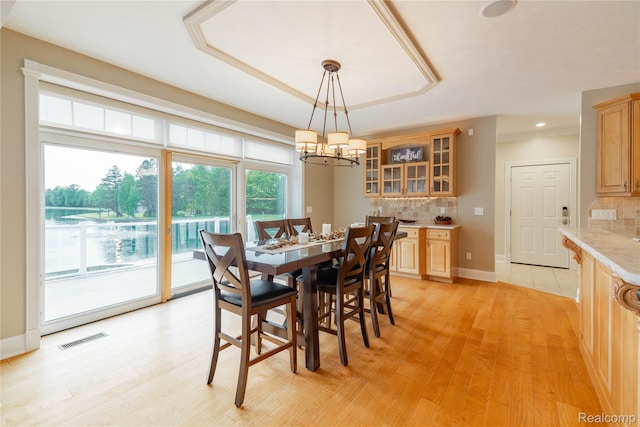6312 S Graham Rd, Saint Charles, MI 48655 - dining space with light wood finished floors, a chandelier, baseboards, and recessed lighting