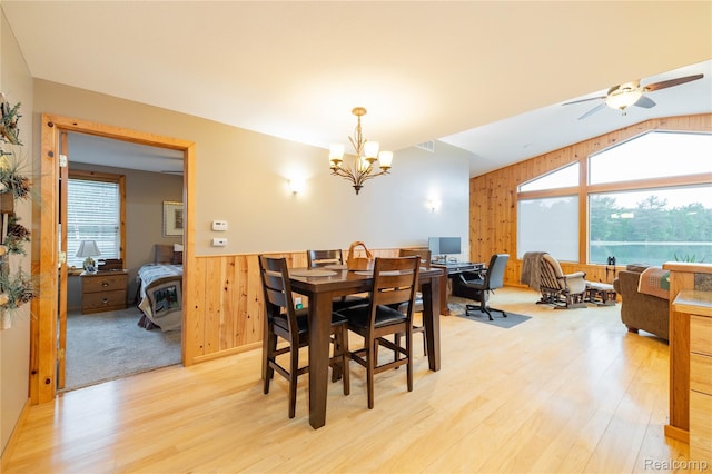6312 S Graham Rd, Saint Charles, MI 48655 - dining area with a chandelier, wood walls, light wood finished floors, wainscoting, and ceiling fan