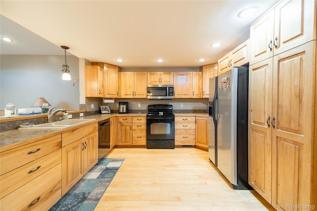 6312 S Graham Rd, Saint Charles, MI 48655 - kitchen with black appliances, a sink, light wood finished floors, light brown cabinetry, and recessed lighting