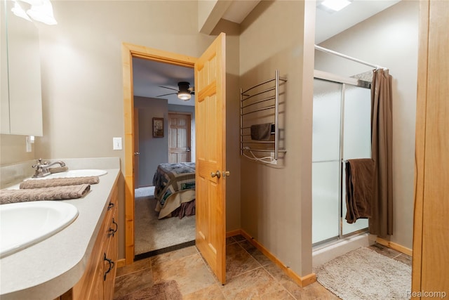 6312 S Graham Rd, Saint Charles, MI 48655 - bathroom with a shower stall, double vanity, a ceiling fan, and ensuite bathroom