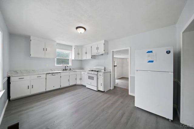 603 Company St, Adrian, MI 49221 - kitchen with white appliances, baseboards, light countertops, white cabinets, and wood finished floors