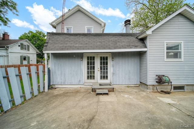 603 Company St, Adrian, MI 49221 - back of property with french doors, roof with shingles, a patio area, and a chimney
