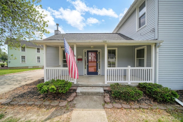 603 Company St, Adrian, MI 49221 - view of front of home featuring a porch and a chimney