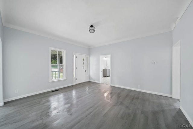 603 Company St, Adrian, MI 49221 - empty room with baseboards, dark wood-style flooring, and crown molding