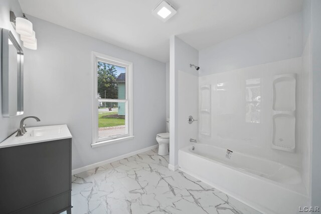 603 Company St, Adrian, MI 49221 - full bath with marble finish floors, toilet, vanity, shower / bath combination, and baseboards