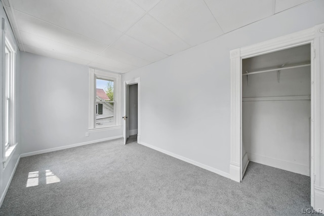 603 Company St, Adrian, MI 49221 - unfurnished bedroom featuring carpet, baseboards, a closet, and a paneled ceiling