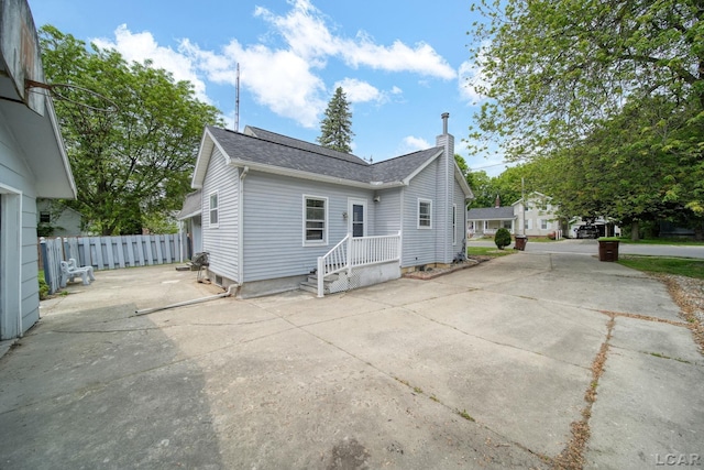 603 Company St, Adrian, MI 49221 - view of front of property featuring a shingled roof and a chimney