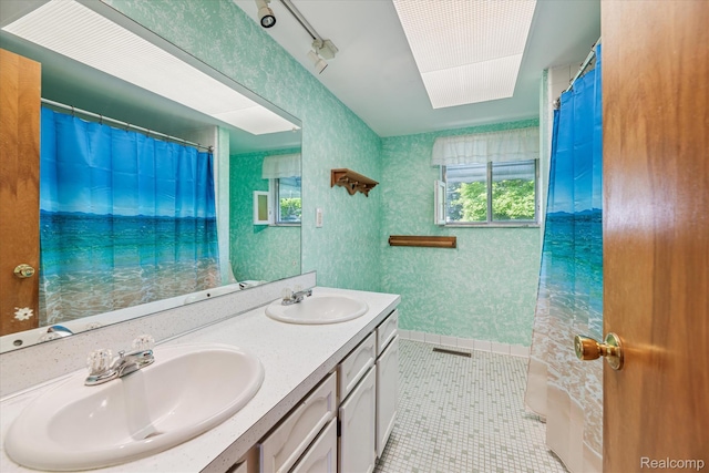 229 Hillview Ter, Fenton, MI 48430 - full bathroom with double vanity, tile patterned flooring, and a shower with shower curtain