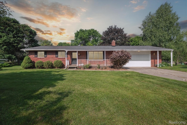 229 Hillview Ter, Fenton, MI 48430 - ranch-style house with brick siding, covered porch, an attached garage, concrete driveway, and a lawn