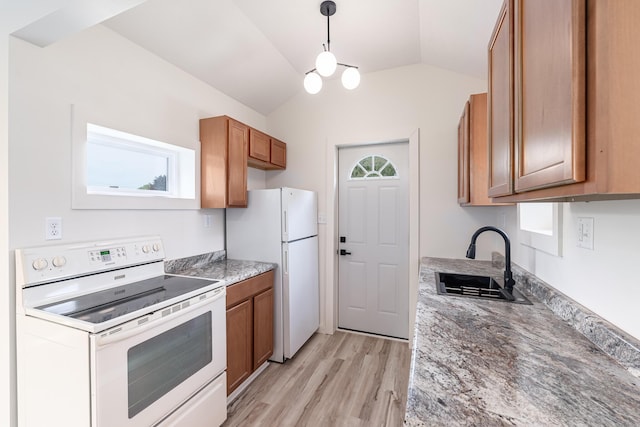 607 S Mill St, Saint Louis, MI 48880 - kitchen with white appliances, a sink, brown cabinetry, lofted ceiling, and light wood-type flooring