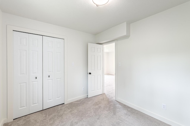 607 S Mill St, Saint Louis, MI 48880 - unfurnished bedroom featuring carpet floors, baseboards, and a closet