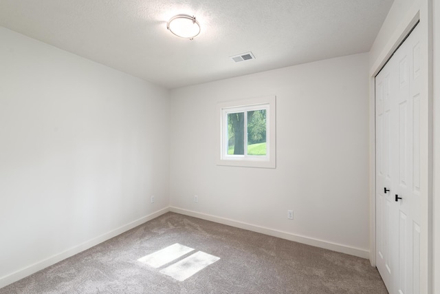 607 S Mill St, Saint Louis, MI 48880 - unfurnished bedroom featuring carpet flooring, a closet, baseboards, and a textured ceiling