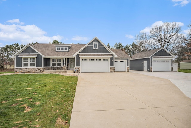 1749 Fairview Dr, Allegan, MI 49010 - craftsman-style home featuring stone siding, a front lawn, and concrete driveway