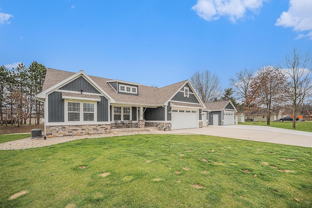 1749 Fairview Dr, Allegan, MI 49010 - craftsman-style house with stone siding, concrete driveway, a front lawn, and covered porch