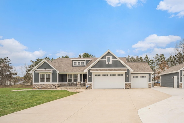 1749 Fairview Dr, Allegan, MI 49010 - craftsman-style house featuring stone siding, driveway, a front lawn, and an attached garage