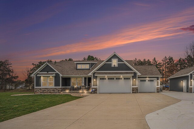 1749 Fairview Dr, Allegan, MI 49010 - craftsman-style house featuring stone siding, concrete driveway, a front yard, a garage, and roof with shingles
