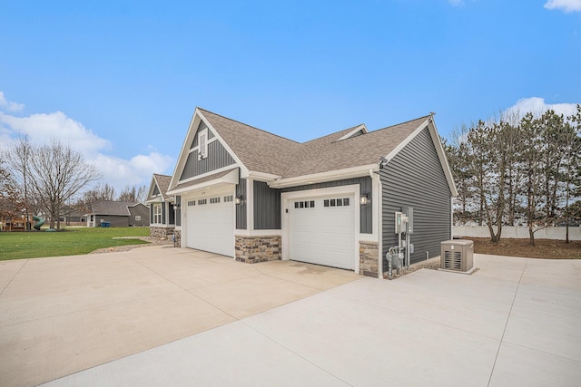1749 Fairview Dr, Allegan, MI 49010 - view of side of property featuring stone siding, a shingled roof, concrete driveway, a lawn, and board and batten siding
