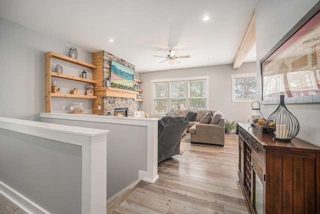 1749 Fairview Dr, Allegan, MI 49010 - living area featuring a stone fireplace, ceiling fan, light wood-style floors, and recessed lighting