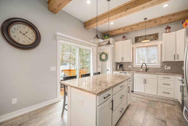 1749 Fairview Dr, Allegan, MI 49010 - kitchen with a sink, decorative backsplash, healthy amount of natural light, beamed ceiling, and a kitchen island