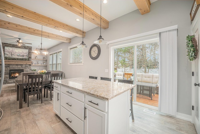 1749 Fairview Dr, Allegan, MI 49010 - kitchen with ceiling fan, beamed ceiling, light wood-type flooring, a center island, and hanging light fixtures