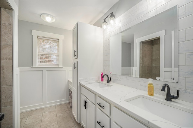 1749 Fairview Dr, Allegan, MI 49010 - full bathroom featuring double vanity, a decorative wall, and a wainscoted wall