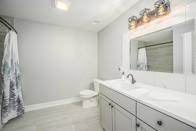 1749 Fairview Dr, Allegan, MI 49010 - bathroom with vanity, toilet, baseboards, and a shower with shower curtain