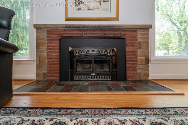 16926 Beverly Rd, Beverly Hills, MI 48025 - detailed view of a tile fireplace, baseboards, and wood finished floors