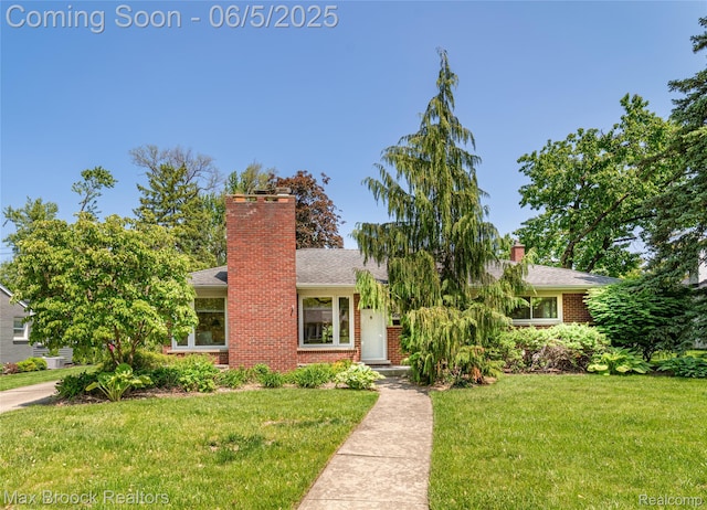 16926 Beverly Rd, Beverly Hills, MI 48025 - view of front of property with a chimney, a front lawn, and brick siding