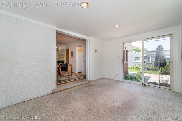 16926 Beverly Rd, Beverly Hills, MI 48025 - spare room featuring a chandelier, carpet floors, brick wall, and recessed lighting