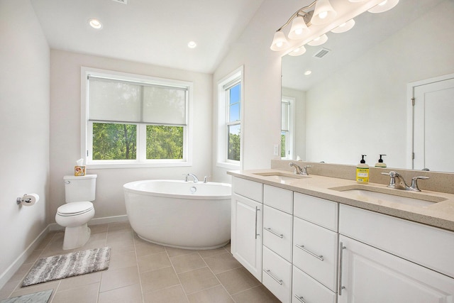 2990 Stoke Way, Ann Arbor, MI 48105 - full bath with double vanity, a freestanding bath, toilet, baseboards, and tile patterned floors